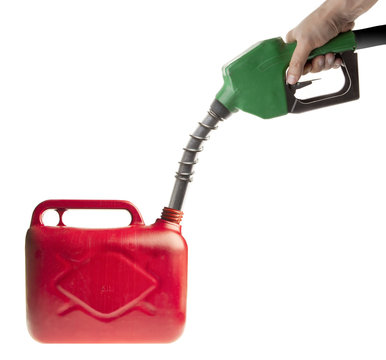 Male hand filling fuel in a red canister on white
