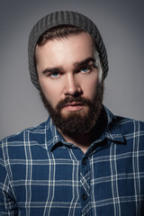 Obraz premium Handsome bearded man in checkered shirt