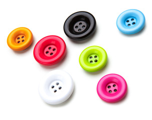 Brightly colored sewing buttons on white background