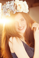 Naklejka premium Happy Fashion Model Woman with Red Hair and Flowers in Sunlight