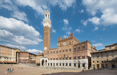 SIENA, ITALY - June 13, 2015: tourists enjoy Piazza del Campo square in Siena, Italy.
