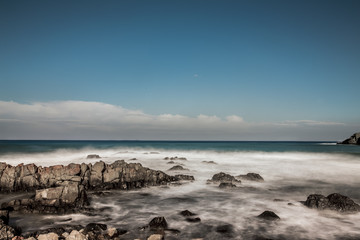 Fototapeta na wymiar Long exposure stones on the beach