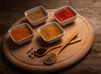 Colorful spices on rustic wooden table