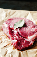 Raw ribeye steak on brown paper with salt