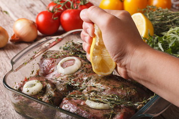 Squeezing lemon juice in the marinade for meat. horizontal
 - obrazy, fototapety, plakaty