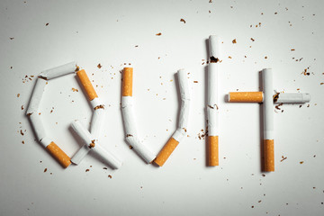 Broken cigarettes arranged as a word quit