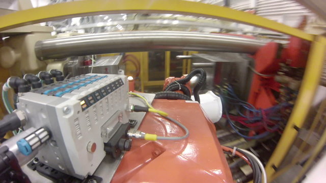 Time lapse with a wide-angle, point-of-view GoPro shot from a robotic arm in a factory.