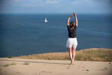 Fototapeta na wymiar Young woman relaxing on the dune