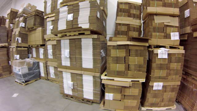 Time lapse point-of-view shot, moving through a large factory and warehouse.
