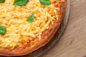 Cheese pizza with basil on table close up