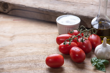 Ingredients for a typical italian lunch lying on a wooden table