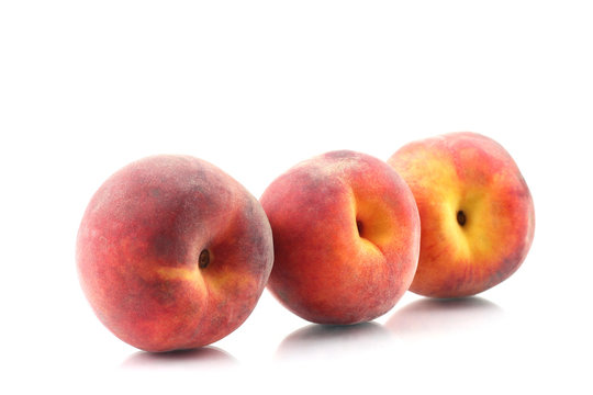 three ripe peach on a white background