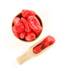 Dried kumquat fruits in wooden bowl, isolated on white
