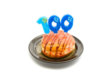 donut with one hundred years birthday candle on white