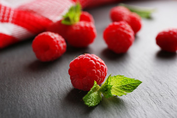 Fresh red raspberries on wooden table, closeup
