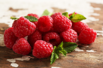 Fresh red raspberries on rustic wooden table, closeup