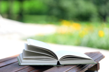 Stack of books outdoors, on blurred background