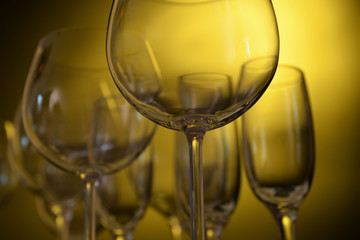 Empty wine glasses on yellow background