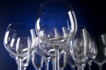 Empty wine glasses on blue background