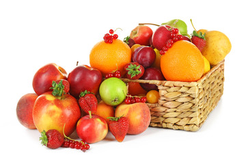 Heap of fresh fruits and berries in basket isolated on white