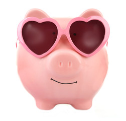Pink piggy bank in sunglasses isolated on white