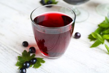 Fresh currant juice with berries on table close up