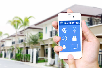 Hand holding mobile smart phone with smart home application on s