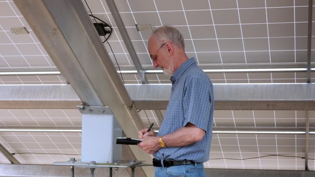 Solar Panel Engineer Inspecting Energy Equipment