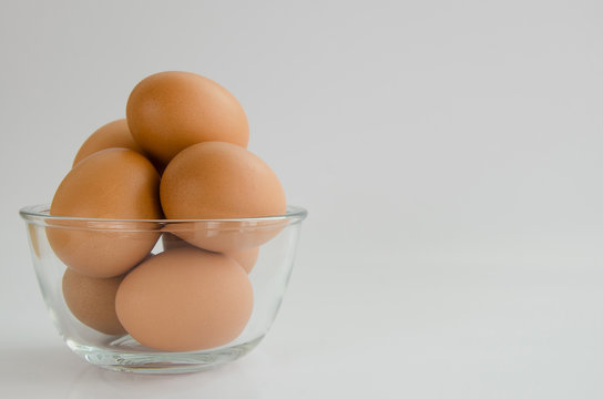 Eggs In Glass Bowl On White Background.