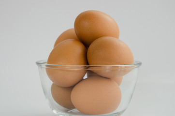 Eggs In Glass Bowl On White Background.