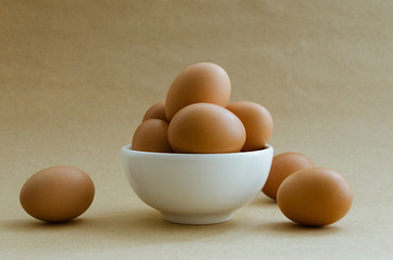 Eggs In White Bowl On Brown Background.