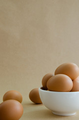 Eggs In White Bowl On Brown Background.