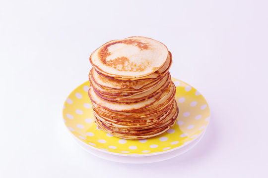 Stack of pancakes on a plate isolated on white background.