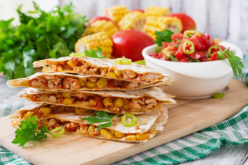 Mexican Quesadilla wrap with chicken, corn and sweet pepper and salsa.