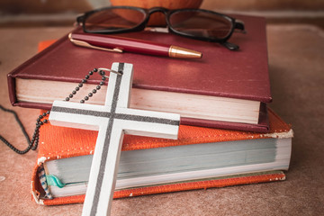 The cross against the book.
