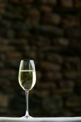 A lone glass of white wine.
