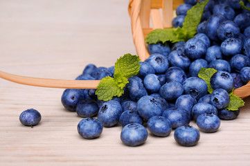 Blueberries in basket on wooden table