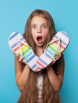 Young surprised girl with flip flops