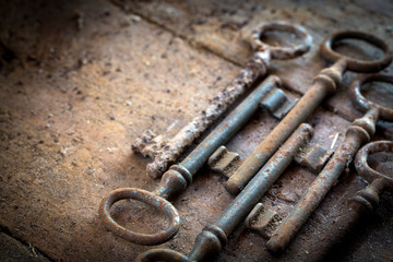 Old rusty keys on a wooden table