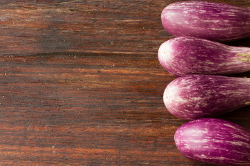 small eggplant on a wooden cutting board