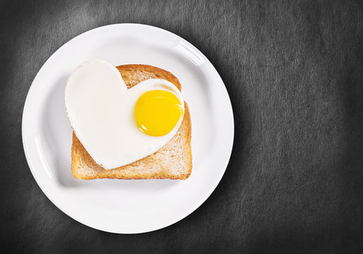 heart-shaped fried eggs and fried toast