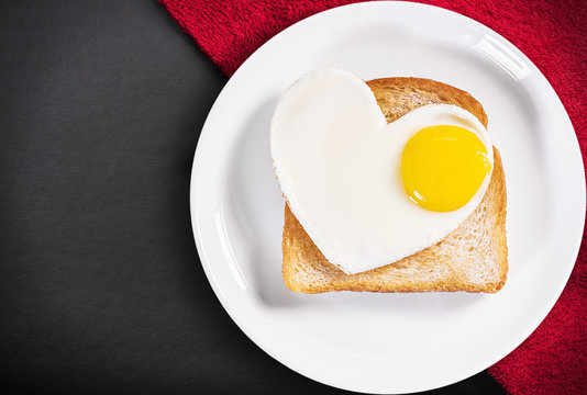 heart-shaped fried eggs and fried toast