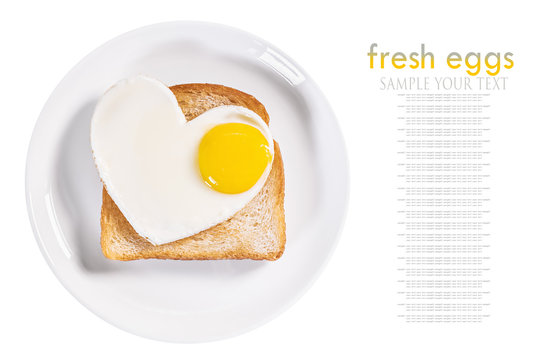 heart-shaped fried eggs and fried toast isolated