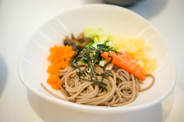 Noodle dish with vegetables and spices in Japanese restaurant