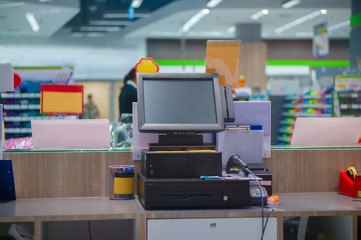Empty cash desk terminal with computer touch screen in departmen