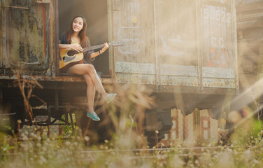 Beautiful girl playing to guitar on Bogies.
