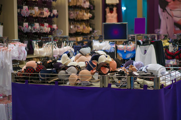 Bunch of variety different colors bras on table in cloth store