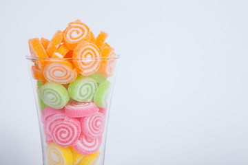 Jelly sweet, flavor fruit, candy dessert colorful in glass on wh