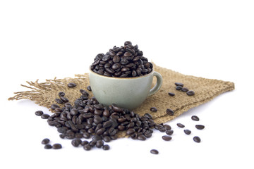 Stock Photo:.Cup full of coffee beans on the cloth sack