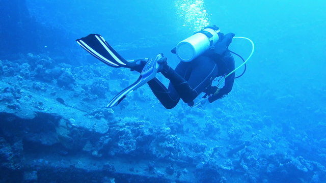Diver moves along the wreck